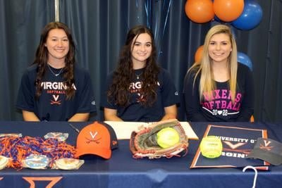 Raiders' softball trio sign collegiate letters of intent