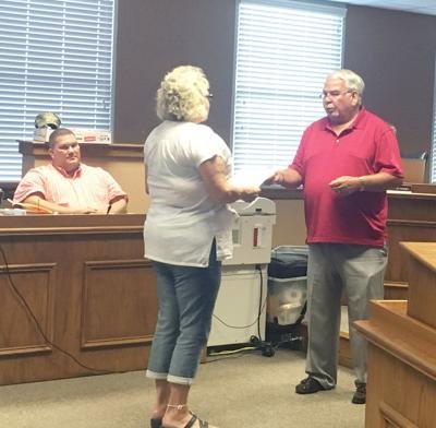Sammy Carter presents a resolution honoring Debbie Dudley
